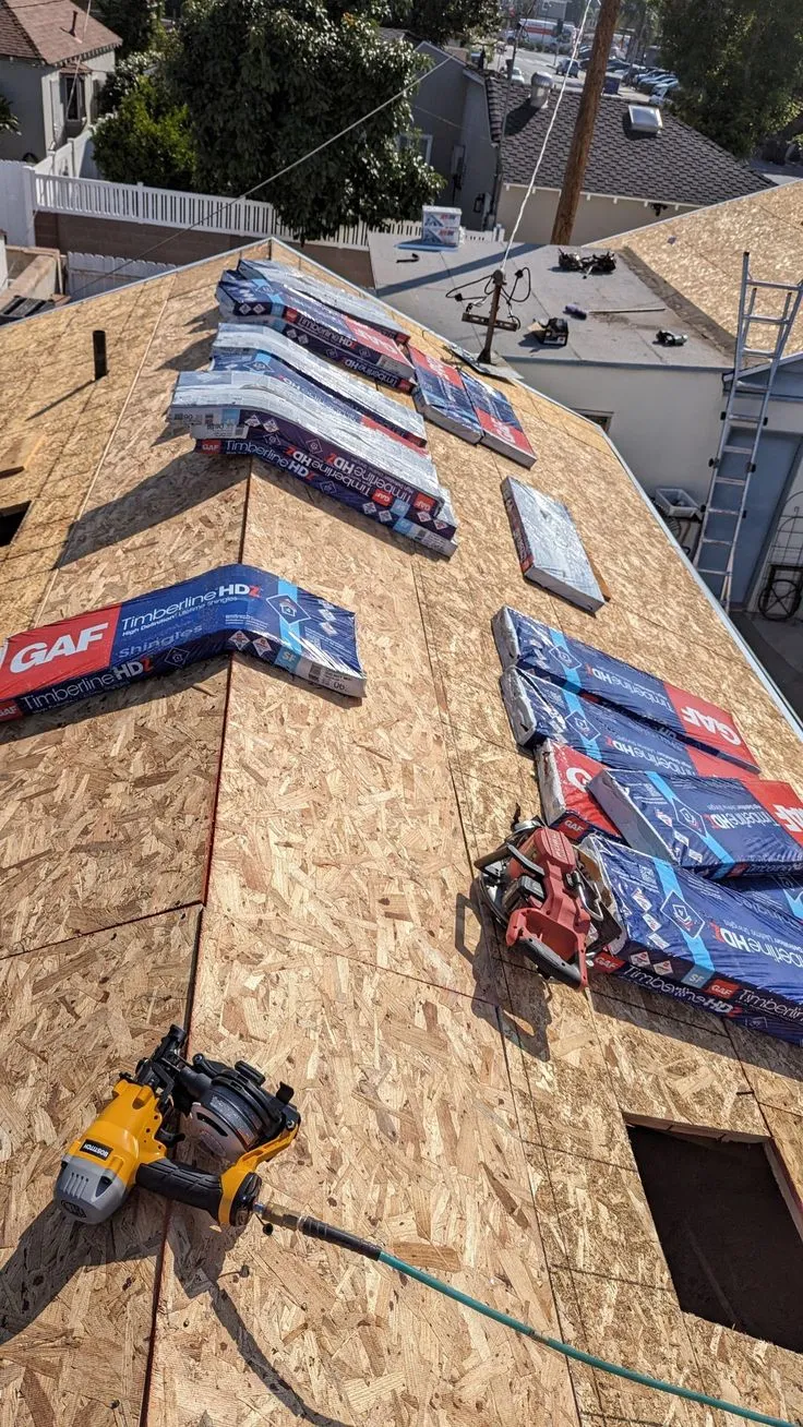 The Quick Guys inspecting roof shingles and flashing for leaks